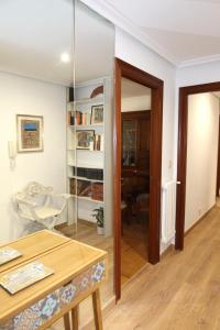 a living room with a table and a glass door at Apartamento Victoria in Valencia de Don Juan