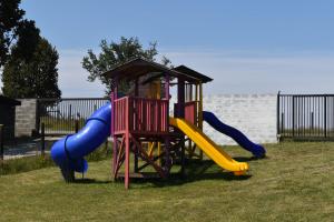 a playground with a slide and a play structure at Cabañas alto Volcanes, Puerto Montt in Puerto Montt