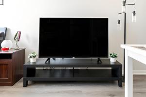 ein schwarzes Entertainment-Center mit einem Flachbild-TV darauf in der Unterkunft Luxury CN Tower Suites - Save on Monthly Stays in Toronto