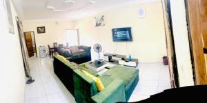 a living room with a couch and a table at Prestige Residence in Korhogo