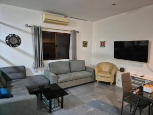 a living room with two couches and a flat screen tv at Dorothys in Pattaya South