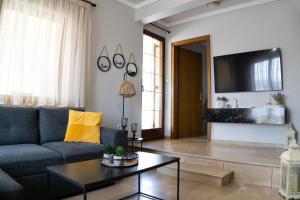 a living room with a couch and a table at Rooftop Guesthouse in Kavála
