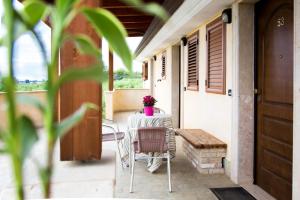 a table and chairs on the porch of a house at Albergo Il Giardino in Rodi Garganico