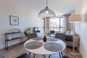 a living room with a white table and chairs at Zerini Appartment in Burgas City