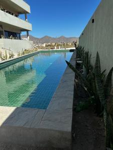 a swimming pool in front of a building at Los Cerritos Oceanview at The Point,8 in San Carlos
