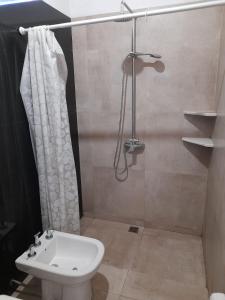 a bathroom with a shower and a toilet and a sink at Alojamiento en catamarca in San Isidro