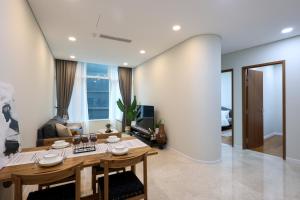 a living room with a table and a couch at Sky Suites KLCC By Calm Sojourn in Kuala Lumpur