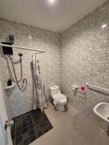 a bathroom with a shower and a toilet and a sink at Dorothys in Pattaya South