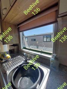 a kitchen with a sink and a window at Beehive 136 snowdon summit 100 in Barmouth +7 photos