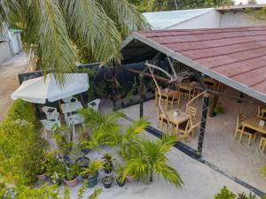 an overhead view of a patio with a table and chairs at Turtle Maldives - Your Gateway to the Beach & Marine Adventures Await! in Omadhoo