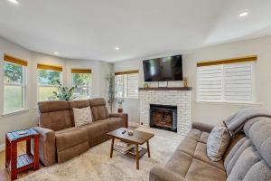 a living room with two couches and a fireplace at Wanderlust Cambria Seaside Village in Cambria
