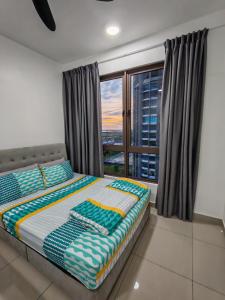 a bedroom with a bed with a view of the city at Bali Residences Melaka by E&E Homestay in Melaka