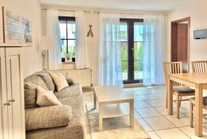 a living room with a couch and a table at Titania 3 in Grömitz