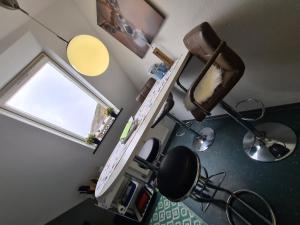 a room with a sewing machine and a window at Ferienwohnungen Dorfliebe Dörnberg TALBLICK in Bestwig