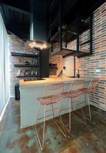 two chairs sitting at a counter in a kitchen at Social Suites by 10E in Medellín