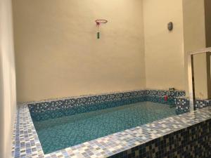 a swimming pool with a basketball hoop in a room at Villa Srikandi Rayya A8 in Tlekung