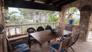 a wooden table and chairs on a patio at Exceptional villa in Mijas with private pool, sea view in Mijas