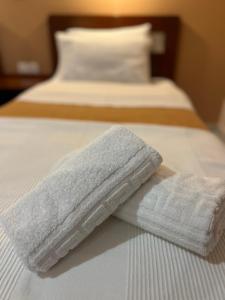 Postel nebo postele na pokoji v ubytování Hotel Nevada Kalamata