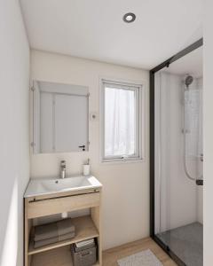 a bathroom with a sink and a mirror at Camp'hôtel Domaine du perche Bellêmois in Bellême +27 photos