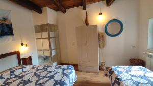 a bedroom with a bed and a mirror on the wall at Tana Libera Tutti 2 Nature, Yourself, Love in Viggianello