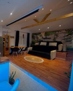 a bedroom with a bed and a table in it at bitty house ALOHA in Boumerdes
