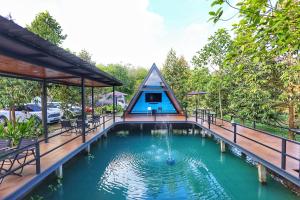 a swimming pool with a pyramid shaped house at สกายโฮม วัดเจดีย์ไอ้ไข่ Resort & Restaurant in Ban Wat Boek