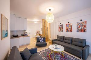 a living room with a couch and a table at Arline's Luxury Retreat House in Sarandë