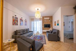a living room with a couch and a table at Arline's Luxury Retreat House in Sarandë
