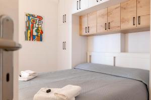 a bedroom with a bed with two towels on it at Arline's Luxury Retreat House in Sarandë