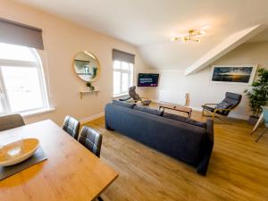 a living room with a couch and a table at Luxury Penthouse Apartment overlooking Main Beach in Bundoran