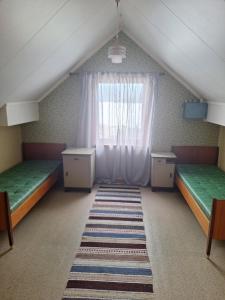 a attic room with two beds and a window at Villa ved sjøen og fjellene in Myklebostad +61 photos