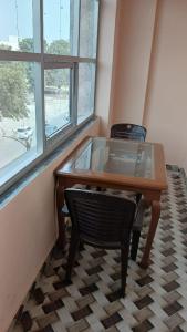 a wooden table and chair in a room with a window at Hotel Rudraksh Palace in Sawāi Mādhopur