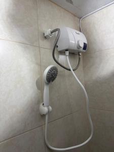 a blow dryer in a shower in a bathroom at Galicia Lodgement in Lima +12 photos