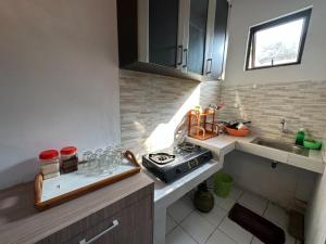 a small kitchen with a stove and a sink at Homestay ngasem 81 in Yogyakarta