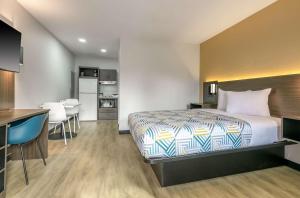 a hotel room with a bed and a kitchen at Studio 6 Columbus GA Columbus Airport in Columbus
