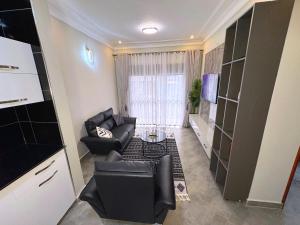 a living room with a couch and a table at Tanzi Homes 1 Manzi in Mbarara