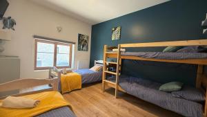 a room with two bunk beds and a window at Gîte Le Verger in Traize