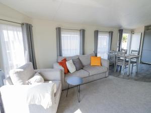 a living room with a couch and a table at Casa De Rhu in Evesham