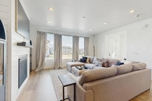 a living room with a couch and a tv at Silver Creek Retreat in Park City