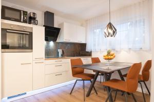 a kitchen and dining room with a table and chairs at Time4you am Bodensee mit Pool Sauna Kamin in Radolfzell am Bodensee