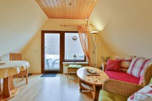 a living room with a couch and a table at Ferienwohnung Heideweg, OG in Zingst