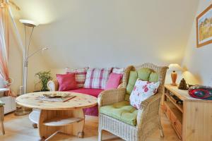 a living room with a couch and a table at Ferienwohnung Heideweg, OG in Zingst