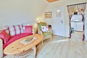 a living room with a couch and a table at Ferienwohnung Heideweg, OG in Zingst