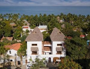 an aerial view of a house with trees and the ocean at Amari Sayulita Boutique Hotel in Sayulita
