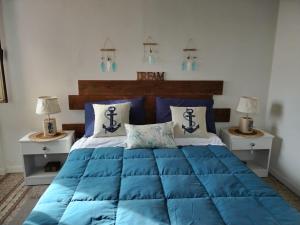 a bedroom with a blue bed with two night stands at Ca'di Lalu in Fezzano
