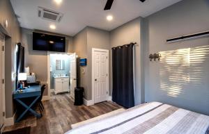 a bedroom with a bed and a desk and a sink at Beautiful studio close to the beach! in Gulfport