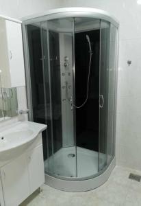 a glass shower in a bathroom with a sink at Guesthouse NADIA in Senj +42 photos