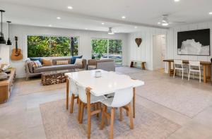 a living room with a white table and chairs at Camp Magic 2 in Hanalei