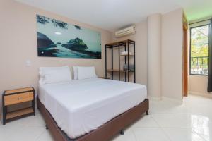 a bedroom with a large white bed in a room at Hotel Tropical San Jeronimo in San Jerónimo +76 photos