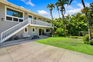 a house with palm trees in front of it at Camp Magic 2 in Hanalei